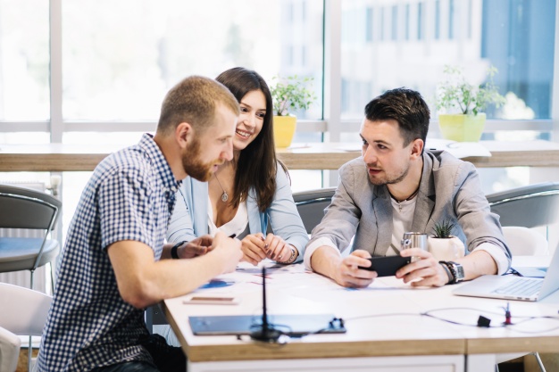 colleagues-discussing-plans-smartphone_23-2147707803.jpg